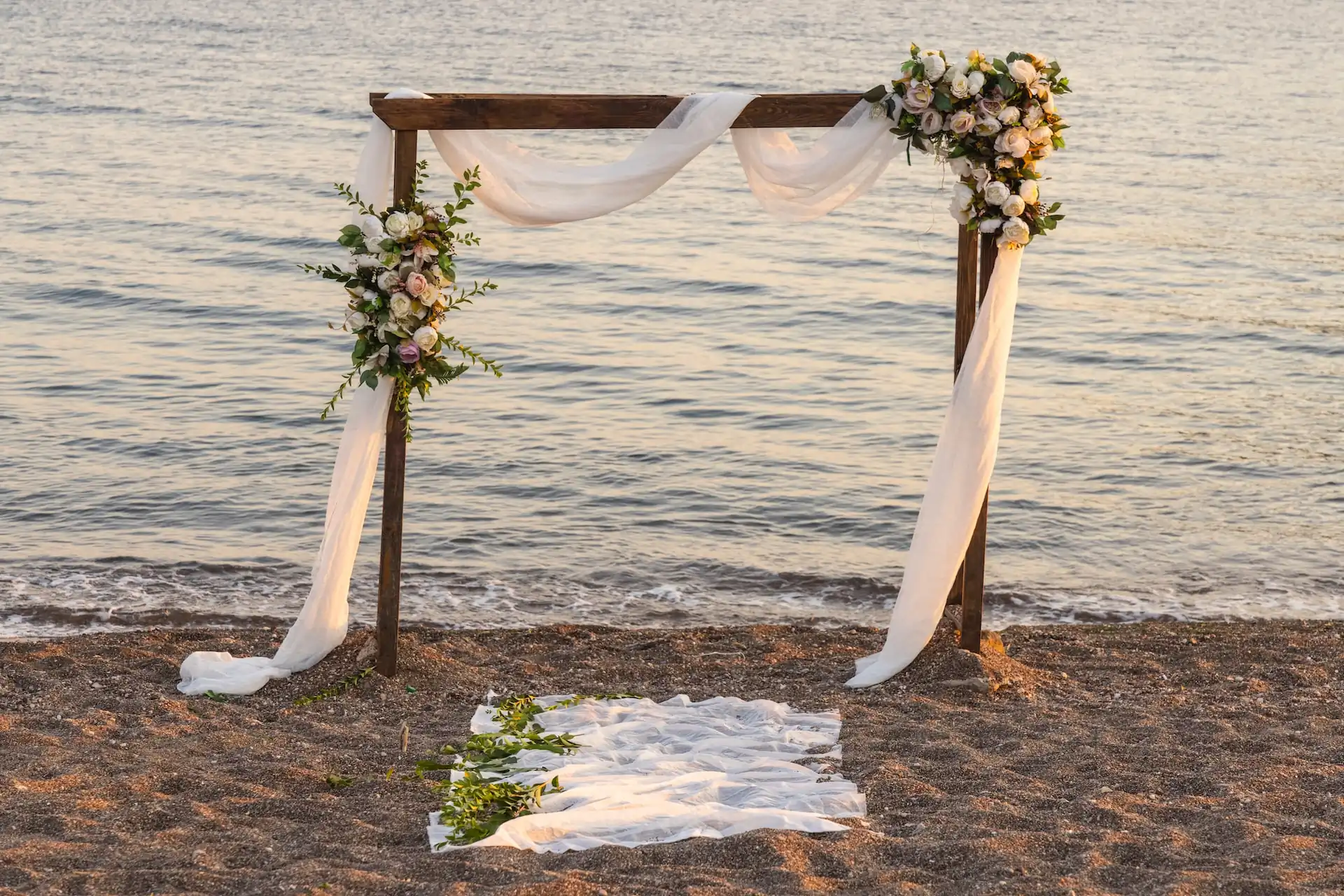 wooden frame with wedding dacorations at the beach